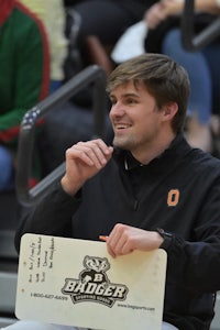 a man holding a sign during a basketball game