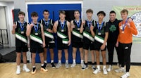 a group of boys posing for a picture with their medals